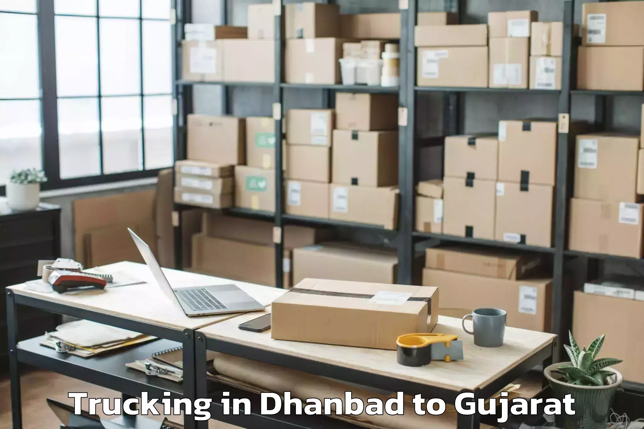 Book Your Dhanbad to Delvada Trucking Today